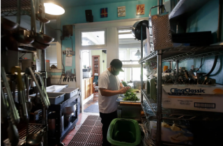 Caregiver holding older woman's hand outdoors
