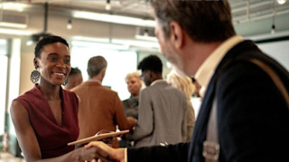 Caregiver holding older woman's hand outdoors