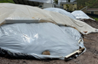 A berm of soil covered in a plastic tarp