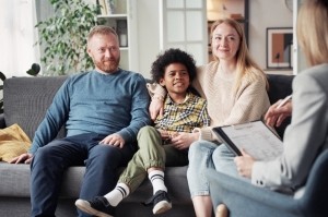 Family with young child meeting with counselor