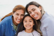 Two adults and 1 child smiling