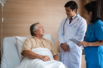 Patient speaking to doctor and nurse