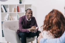 Smiling clinician talking to young couple
