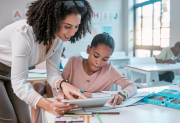 Teacher helping student with project