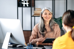 Counselor smiling at student in office