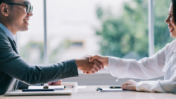 two adults shaking hands