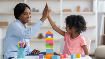 School clinician high fiving young student