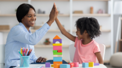 School clinician high fiving young student
