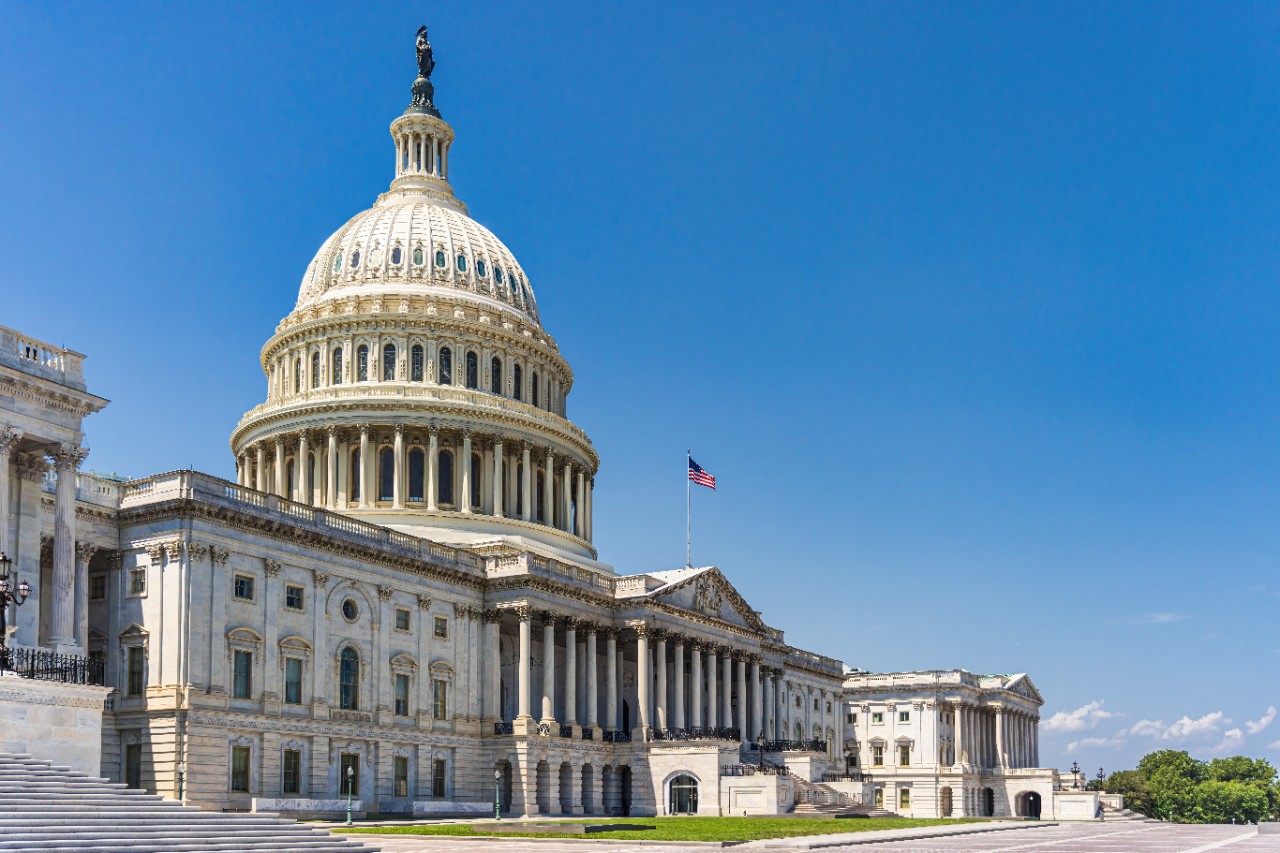 The United States Capitol building with American flag, Washington DC, USA.