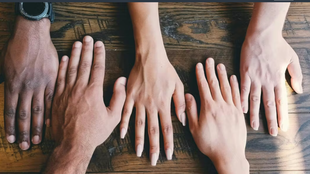 Hands of diverse people on a table 
