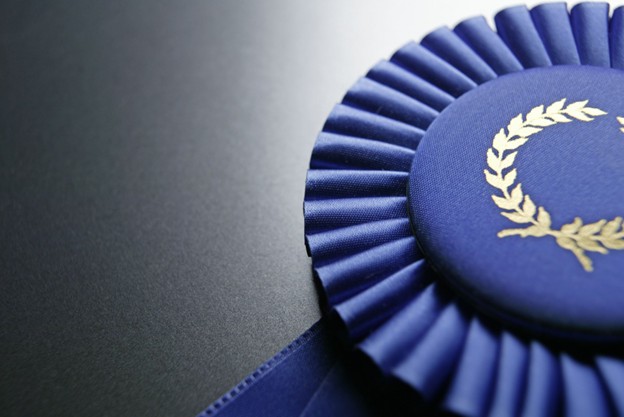 A blue award ribbon on a black background