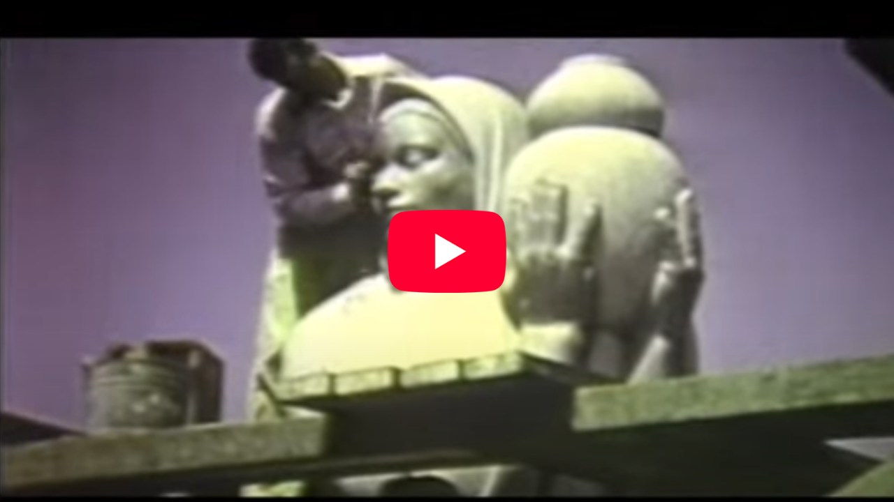 A man sculpting the head of the large granite sculpture in 1939