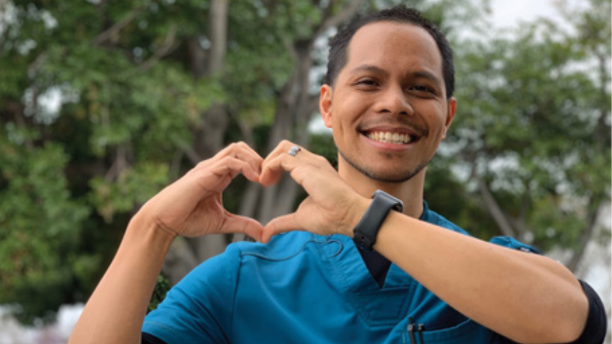 Picture of a man making a heart with his fingers