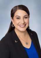 Headshot of Elizabeth Hernández wearing blue top and black jacket 