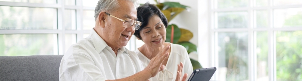 Asian couple searching for information on a tablet