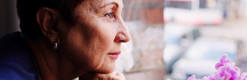 older woman looking out the window