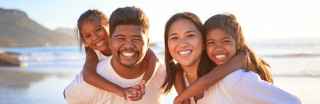 Family smiling at the beach
