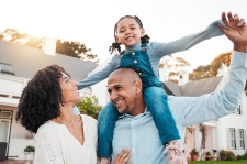 Happy family with daughter on shoulders