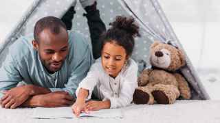 Father and daughter reading together