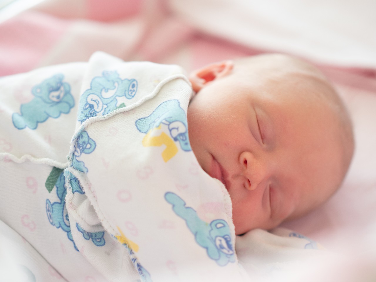 Close-up portrait of sleeping newborn baby in undershirt