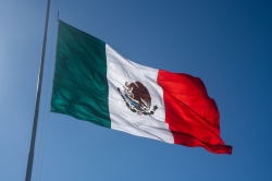 A low angle shot of the Mexican Flag waving on a sunny day in Mazatlan