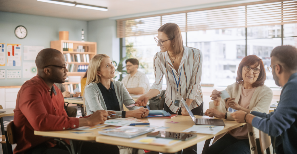 A professional speaking to young adults in a classroom setting.