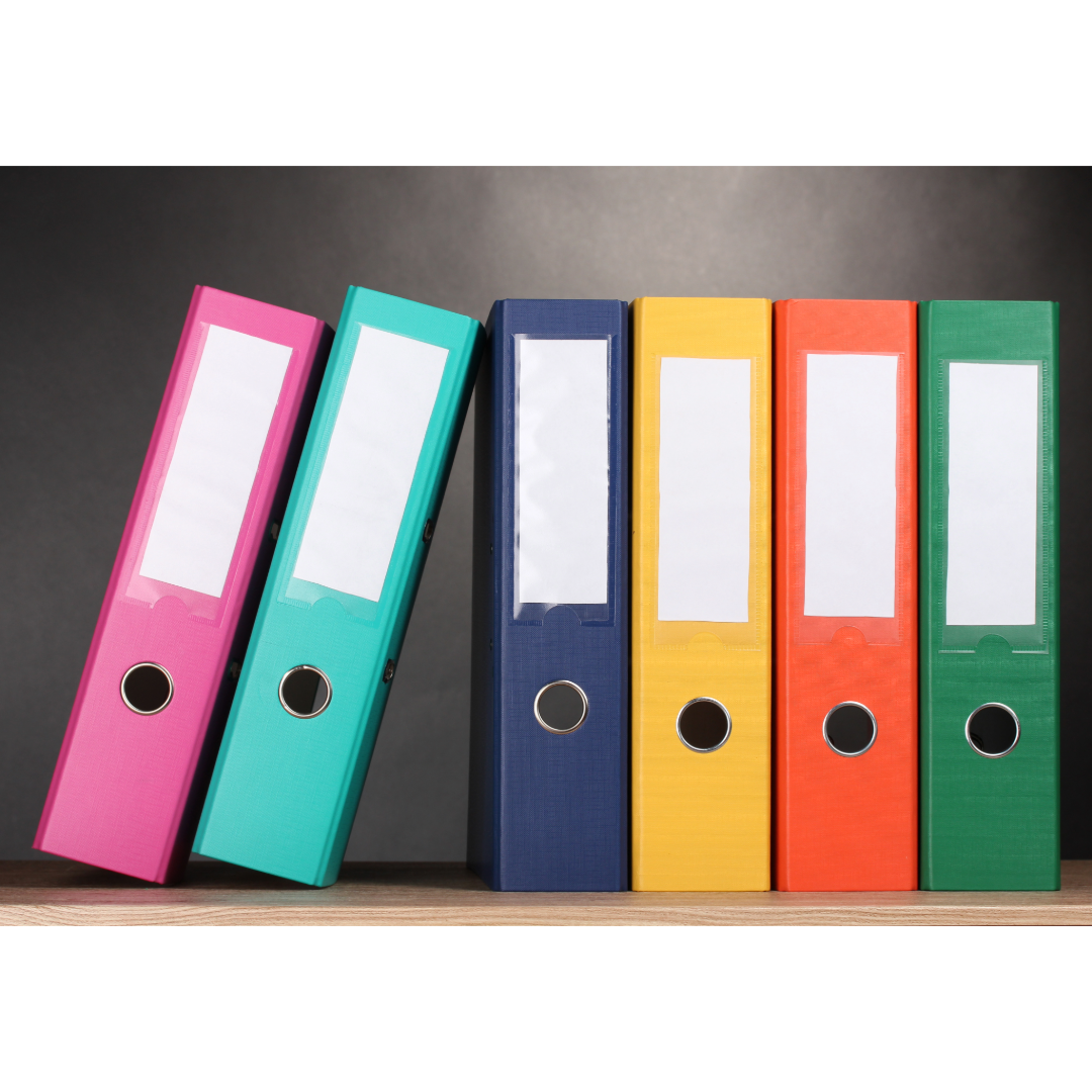 A stack of multi-colored binders.