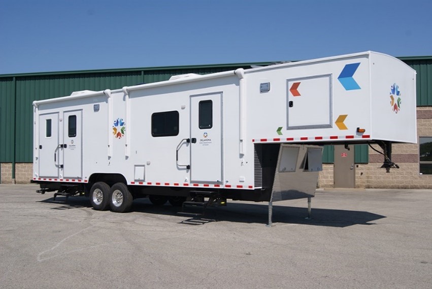 A health care trailer parked outdoor on the road