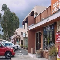 Downtown Alpine storefronts with cars parked in front