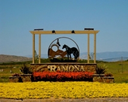 Ramona entrance sign with a mountainous landscape in the background