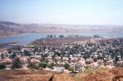 Residential area with a lake and mountains in the background