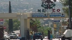 Port of entry into Mexico with vehicles traveling on both sides of the border