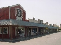 A red barn‑style building that contains several stores