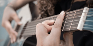 A person playing guitar. A person playing guitar.