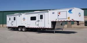 A health care trailer parked outdoor on the road. A health care trailer parked outdoor on the road.
