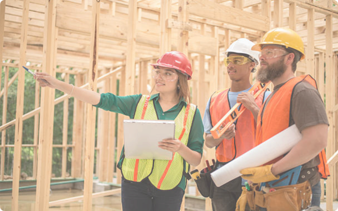 Three people in construction inspecting a structure, representing Building inspections
