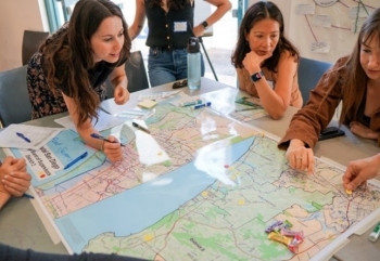 Clara facilitating a group discussion at the Community Climate Conversation