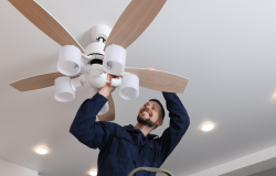 Individual working on a ceiling fan