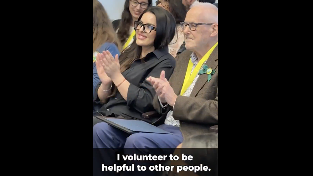 I volunteer to be helpful to other people. People clapping at an awards ceremony.