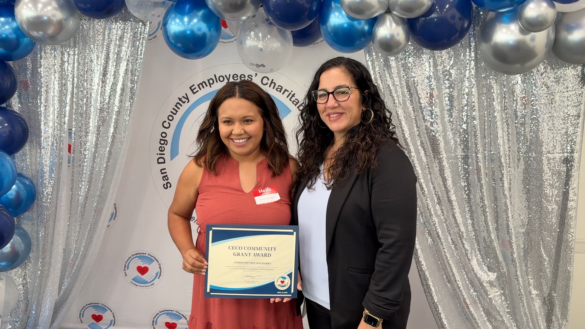 One person presenting a certificate to another.