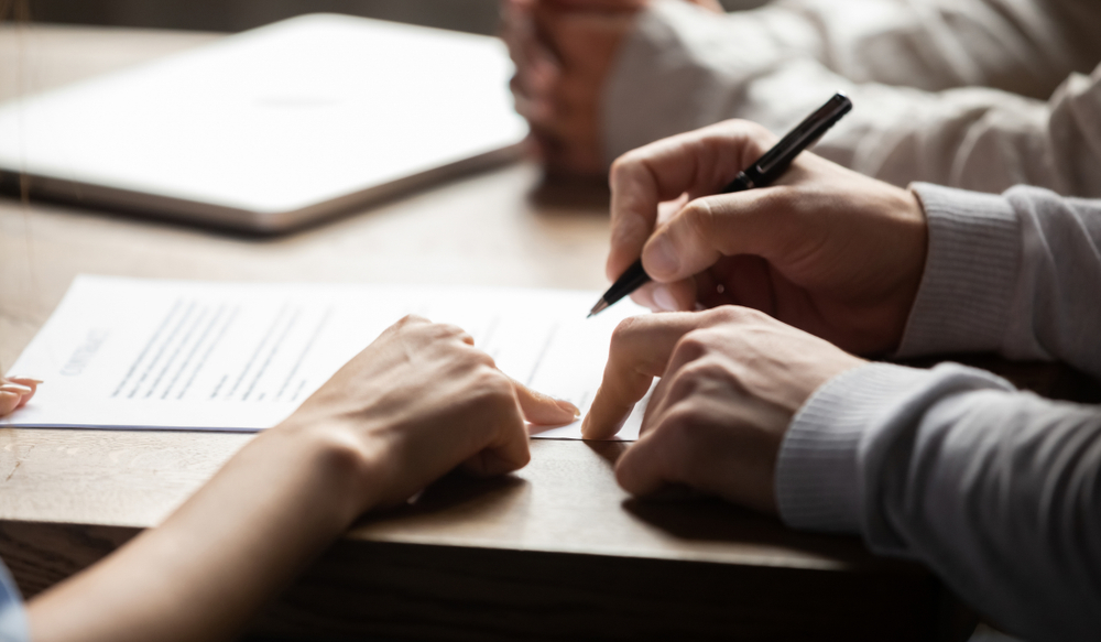 Hands signing contract